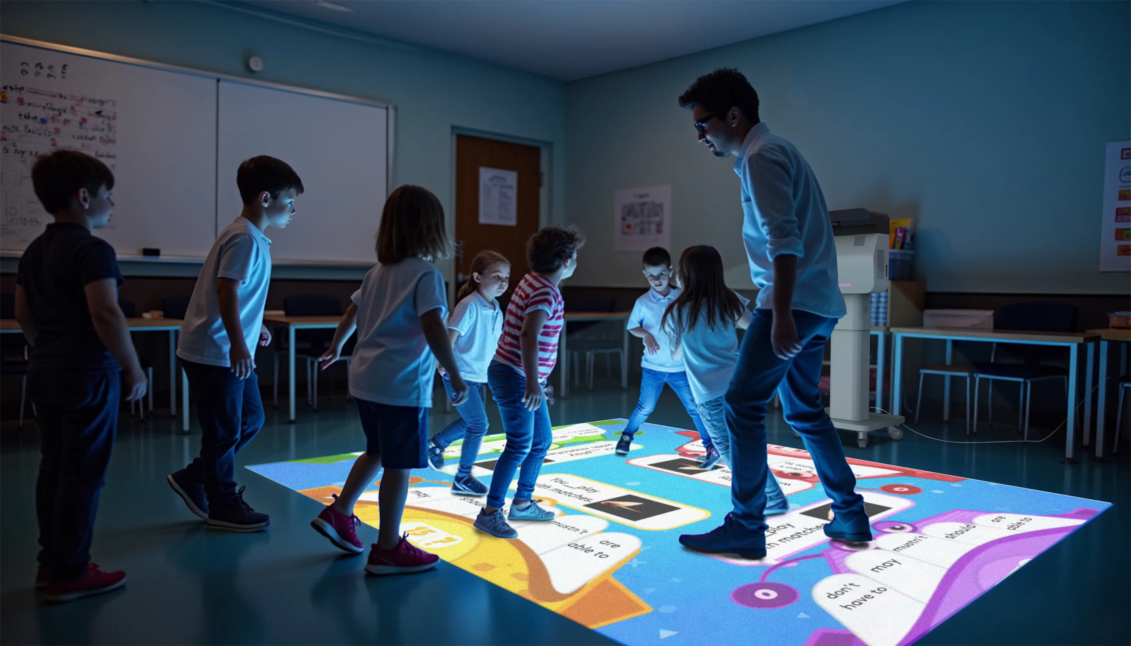 Students and a teacher playing on an interactive floor projection in a dimmed classroom
