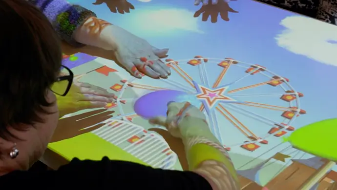 Seniors gathered around an interactive table