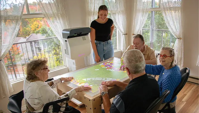 Seniors gathered around an interactive table